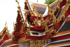 ornate golden carved roof of buddhist temple, thailand