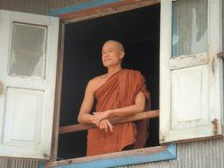 the monk looks out the window