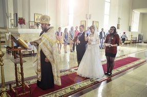 orthodox wedding, pastor, bride and groom in church, russia