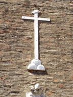 cross on the wall of the cathedral on a sunny day