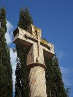 pilgrim's cross near green trees