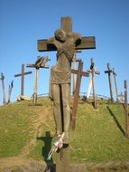 statue of a man on a cross on a hill