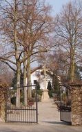 gate to the cemetery with the church