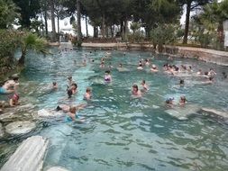 people in the pool among the ruins in Aphrodisias