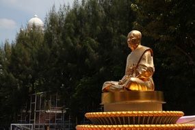 golden monk meditate statue