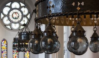 wrought iron ceiling light with dark glass bulbs in church, sweden, hässleholm