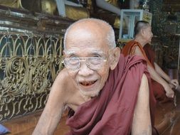 elderly buddhist monk in the temple, myanmar