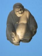 buddha on a blue background in shadow and light