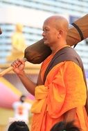 thai monk in orange coat