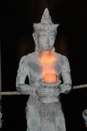 buddha statue with a bowl of fire