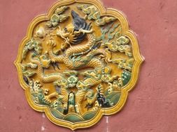 bas-relief with a dragon on a temple in asia