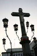 A monument to Christ and five lanterns in Cordoba close-up
