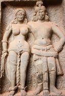 statues of man and woman in karla caves