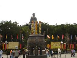people on square at stairway to buddha statue