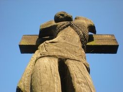 wooden statue of a man on the cross