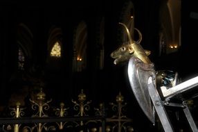 sculpture near a chair in a church