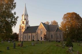 grave yard beside of church at autumn evening, sweden, knista