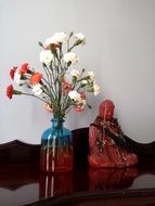 decoration of flowers in a vase near the staat buddha