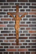 small wooden figurine in the shape of crucified Christ on the wall