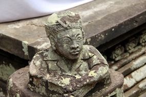 aged stone male bust on temple, indonesia, bali