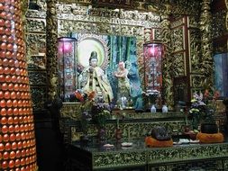 altar with deity sculptures in Asian temple