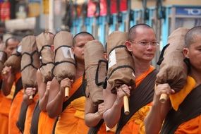 Buddhists in orange coats close-up