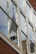 reflection of a church on a building window