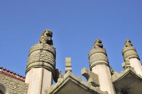 carved pillars and statues on the temple in China