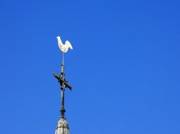 White little cock on a church tower top