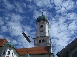 church tower against blue sky with clouds