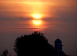 Church spire on sunset background