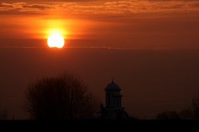 red sky at sunset over the church