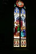 Church window stained glass on a dark wall