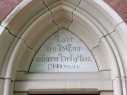 the inscription above the entrance to the church