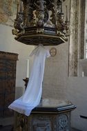 christening gown over baptismal font