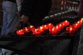 burning wax candles in the temple