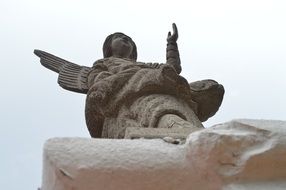 stone statue of an angel on the church