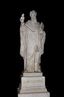 white statue of saint augustine on black background