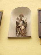 catholic saint statue on wall, austria, klostergasse, fÃ¼rstenfeld