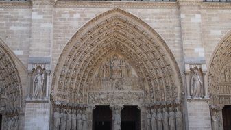 arched entrance to paris church notre dame