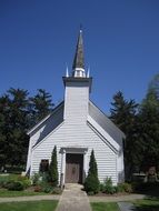 old christian church among green trees