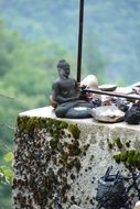 buddha statue and candles on the stone