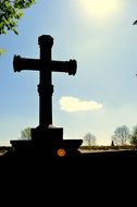 silhouette of cross on christian cemetery at sky