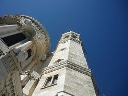 bottom view of the high tower of the cathedral on a sunny day