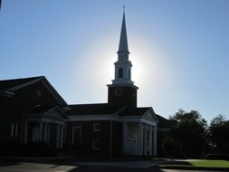 christian church with a spire in the bright sun