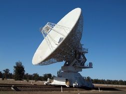 white satellite dish at the observatory at blue sky background