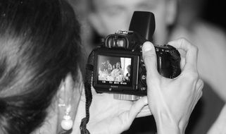 woman looking through photos taken by a camera