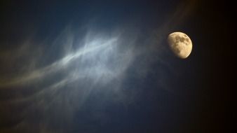 lighted moon on a cloudy sky