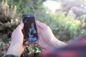 blue smartphone in hand