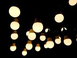 many light bulbs in the night illuminating a place outside